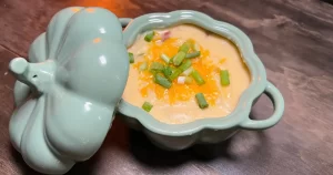 Cozy innkeepers baked potato soup in a pumpkin shaped bowl