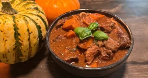 Dungeon Delver Dijon Beef Stew next to some pumpkins