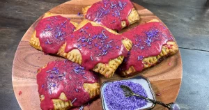 Scanlan's hand pies from exquisite exandria arranged on a plate with a dish of sprinkles