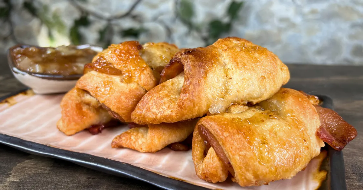 Bacon filled crescent rolls on a plate with a size of fig glaze