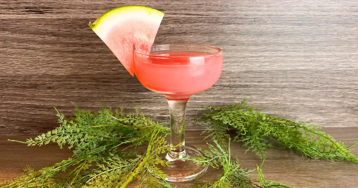 Watermelon lemonade in a glass with a small slice of watermelon as a garnish